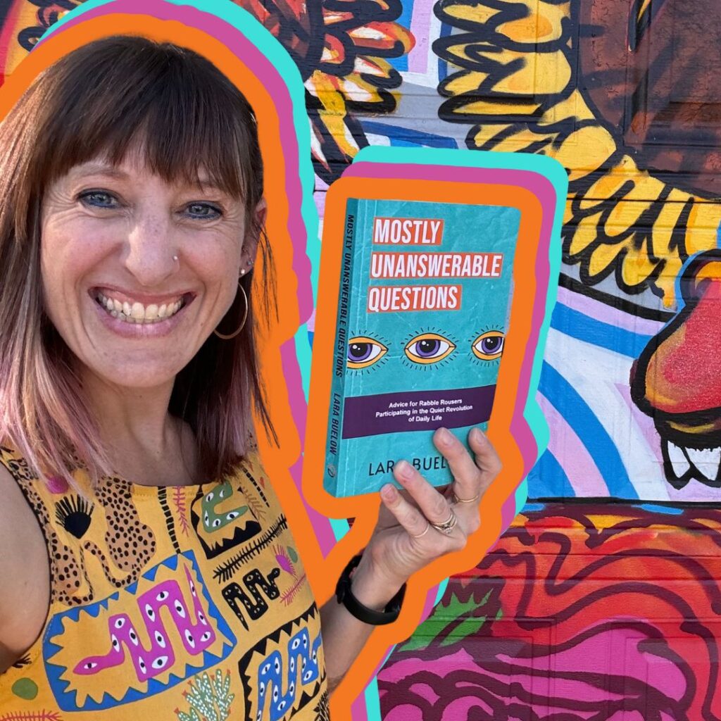 Volunteer Spotlight: Lara Buelow 6 A smiling person with multicolored hair holds a book titled "Mostly Unanswerable Questions" against a vibrant graffiti backdrop. This month's Volunteer Spotlight is on Lara Buelow, whose artful eye design graces the cover of the intriguing read.